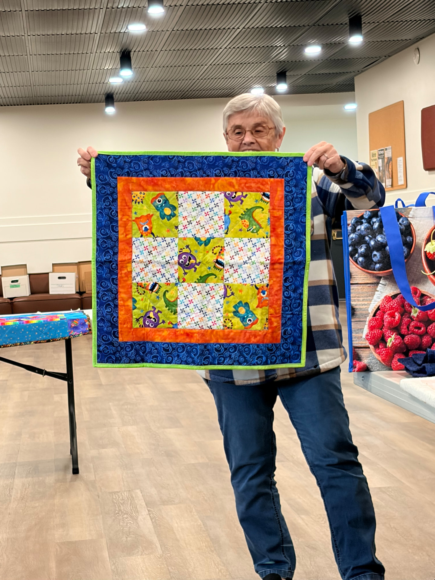 Monster-print baby quilt with playful novelty fabrics