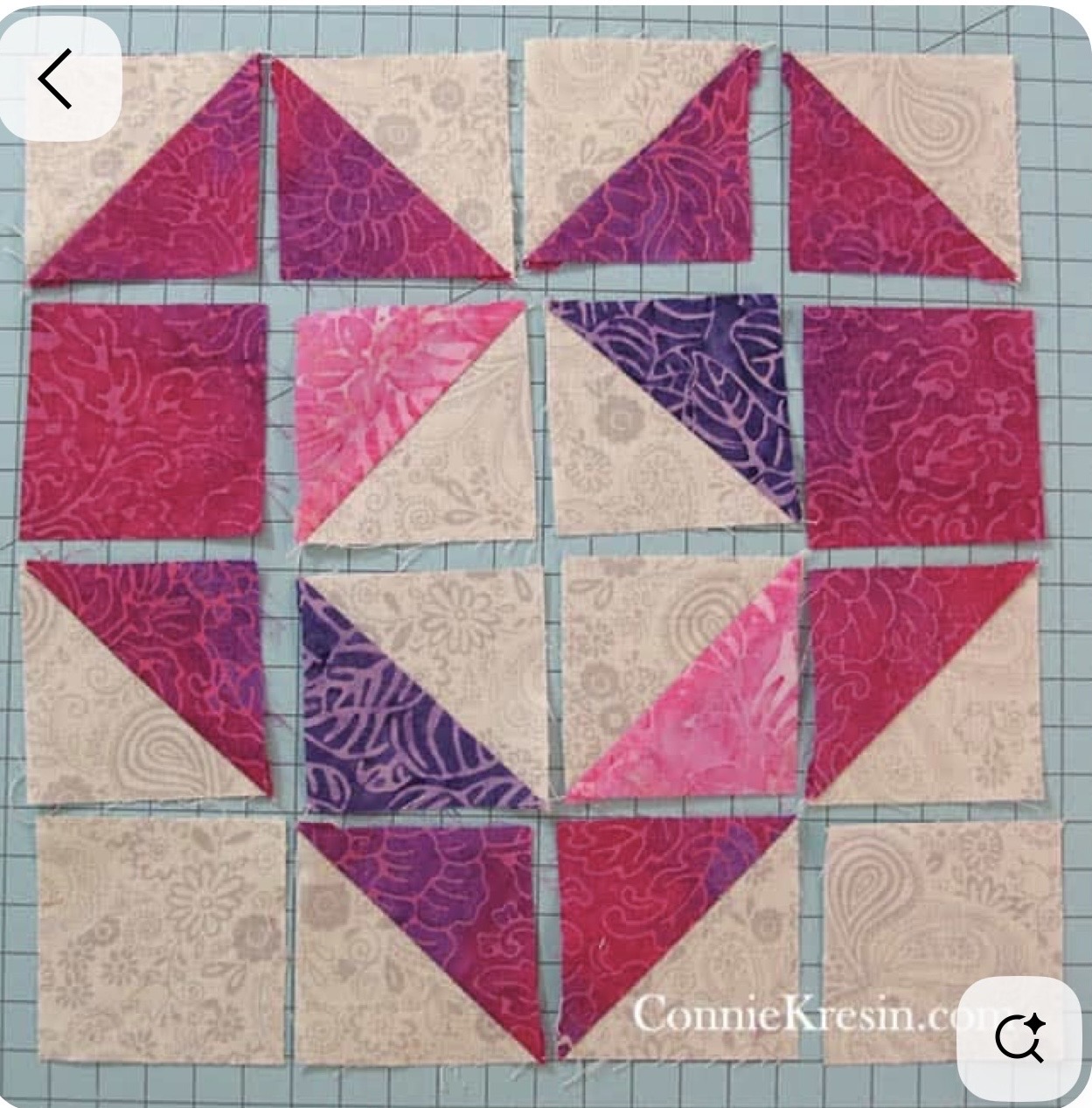 Batik Heart Block — Half-square triangles and squares in pink and purple batiks on a cream background.