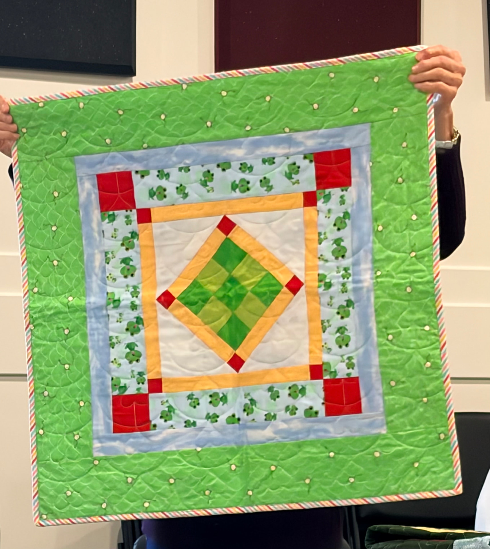 Turtle-print quilt in greens with log cabin blocks