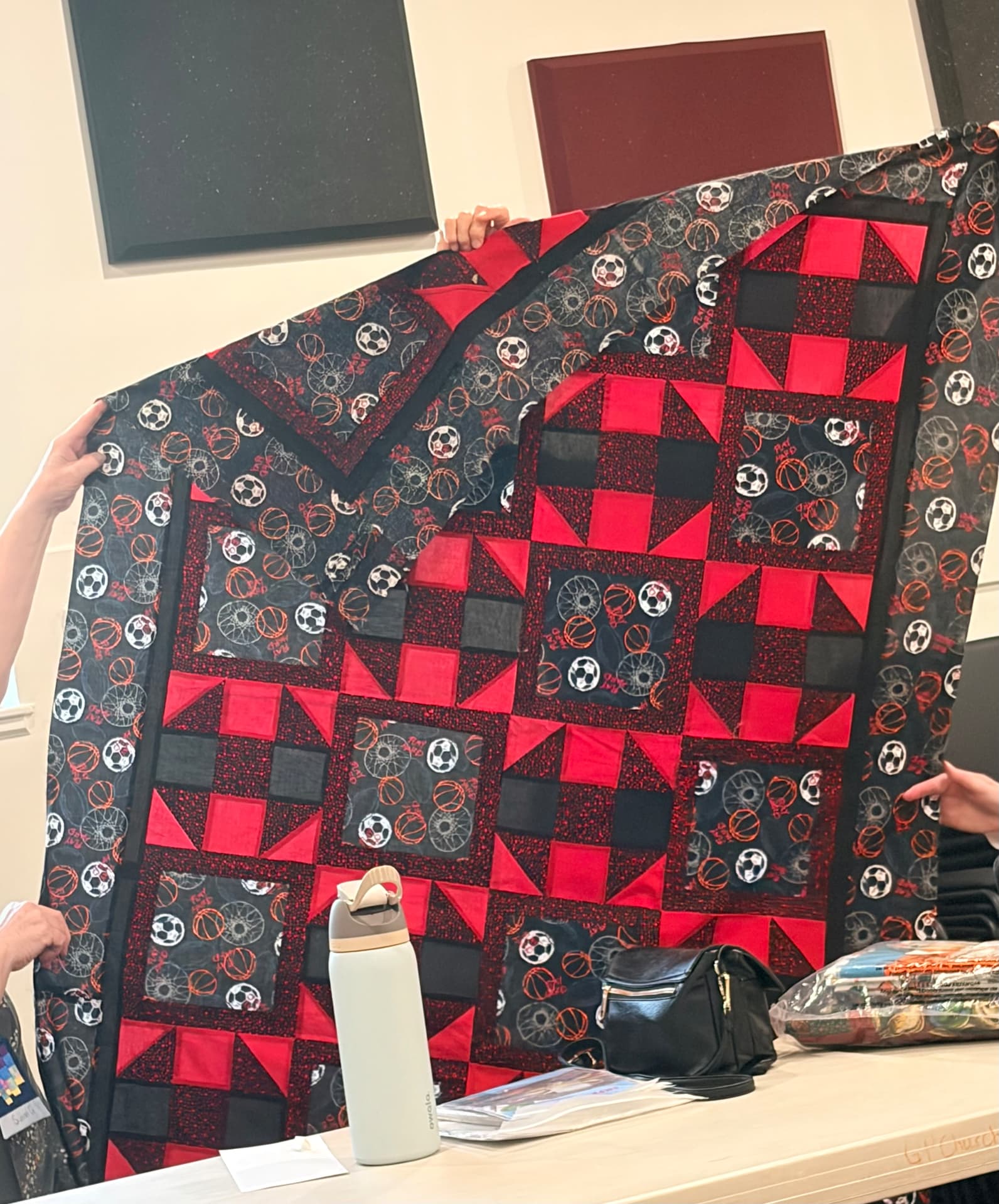 Sports balls quilt in red and black with basketball and soccer print blocks