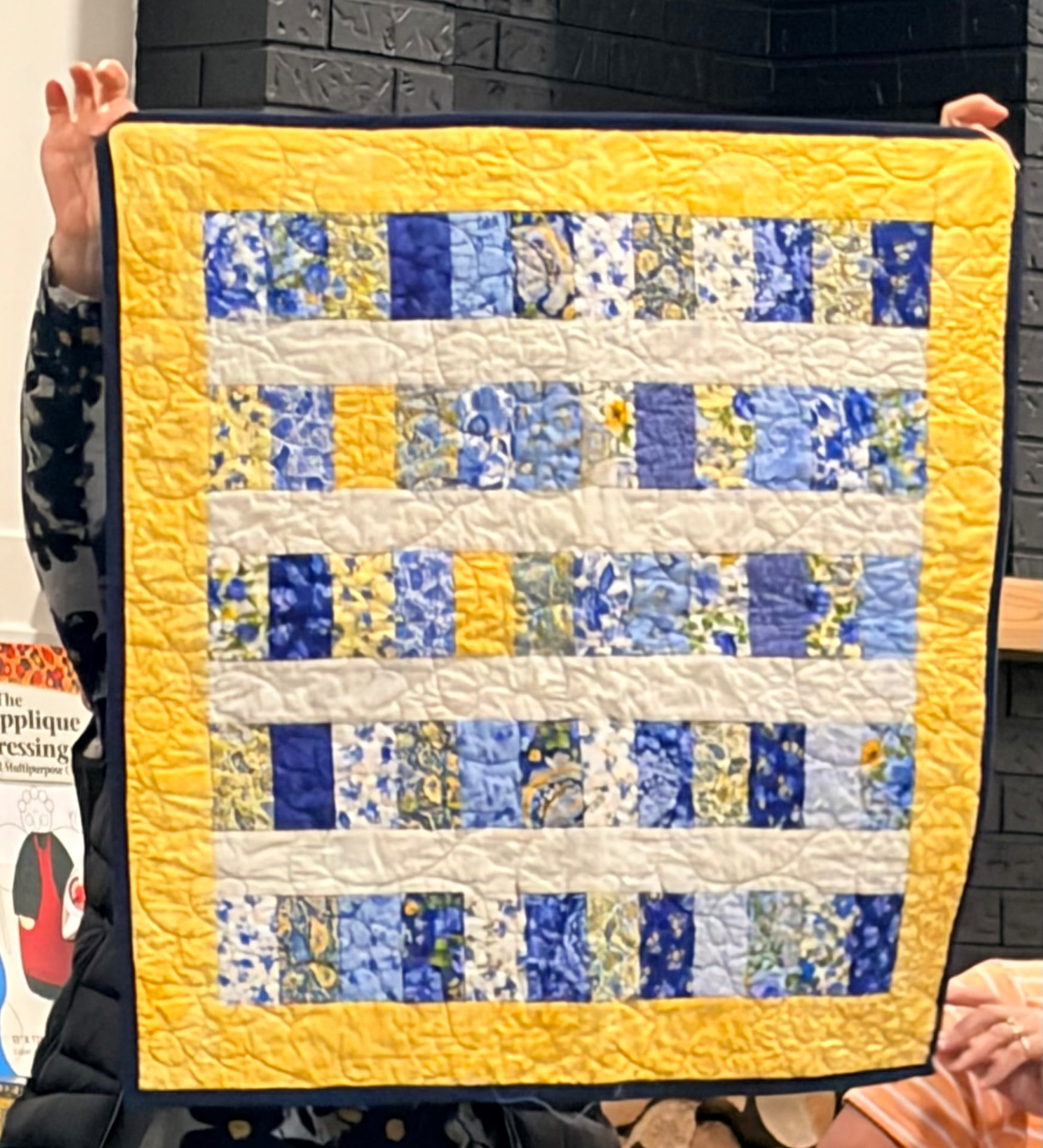 Blue and yellow strip quilt with Van Gogh-inspired swirly prints and a yellow border
