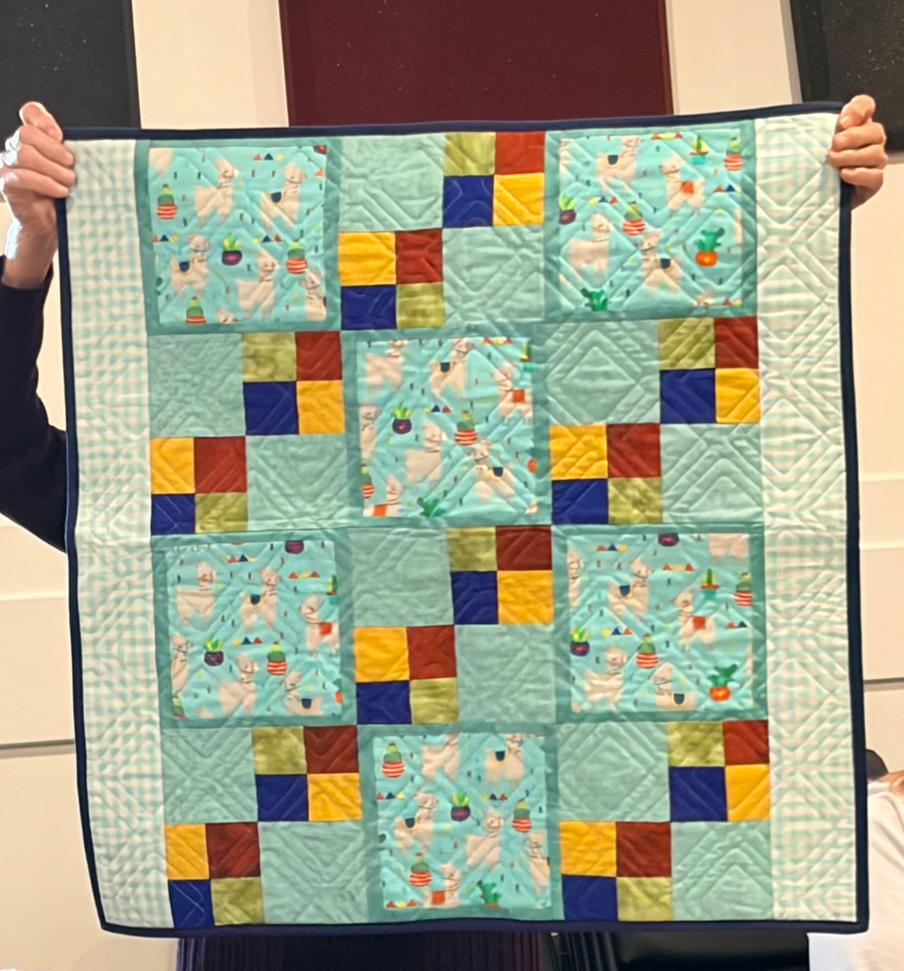 Llama and alpaca print quilt in teal tones