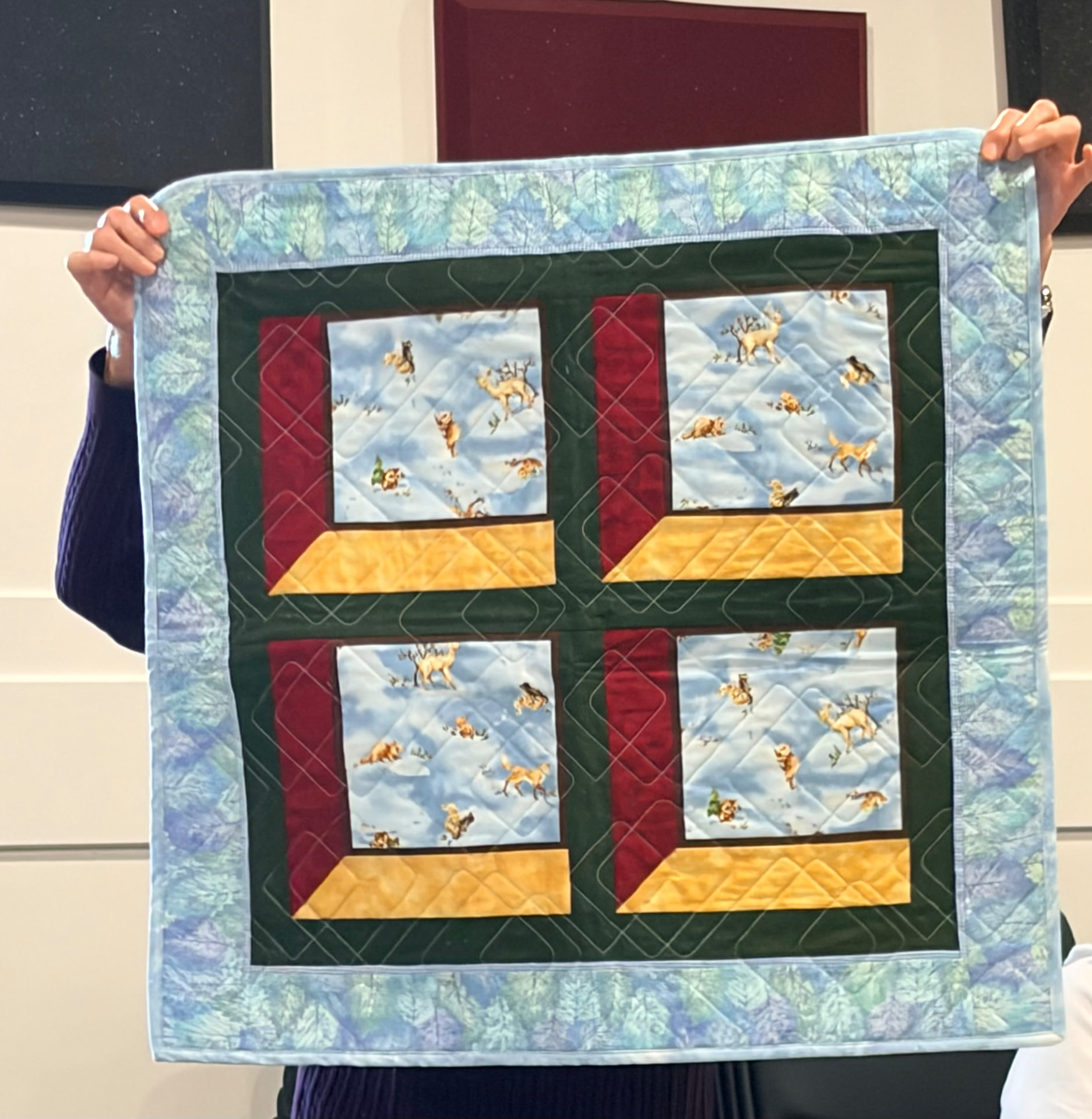 Winter window quilt with snowflake blocks and a multicolour strip border