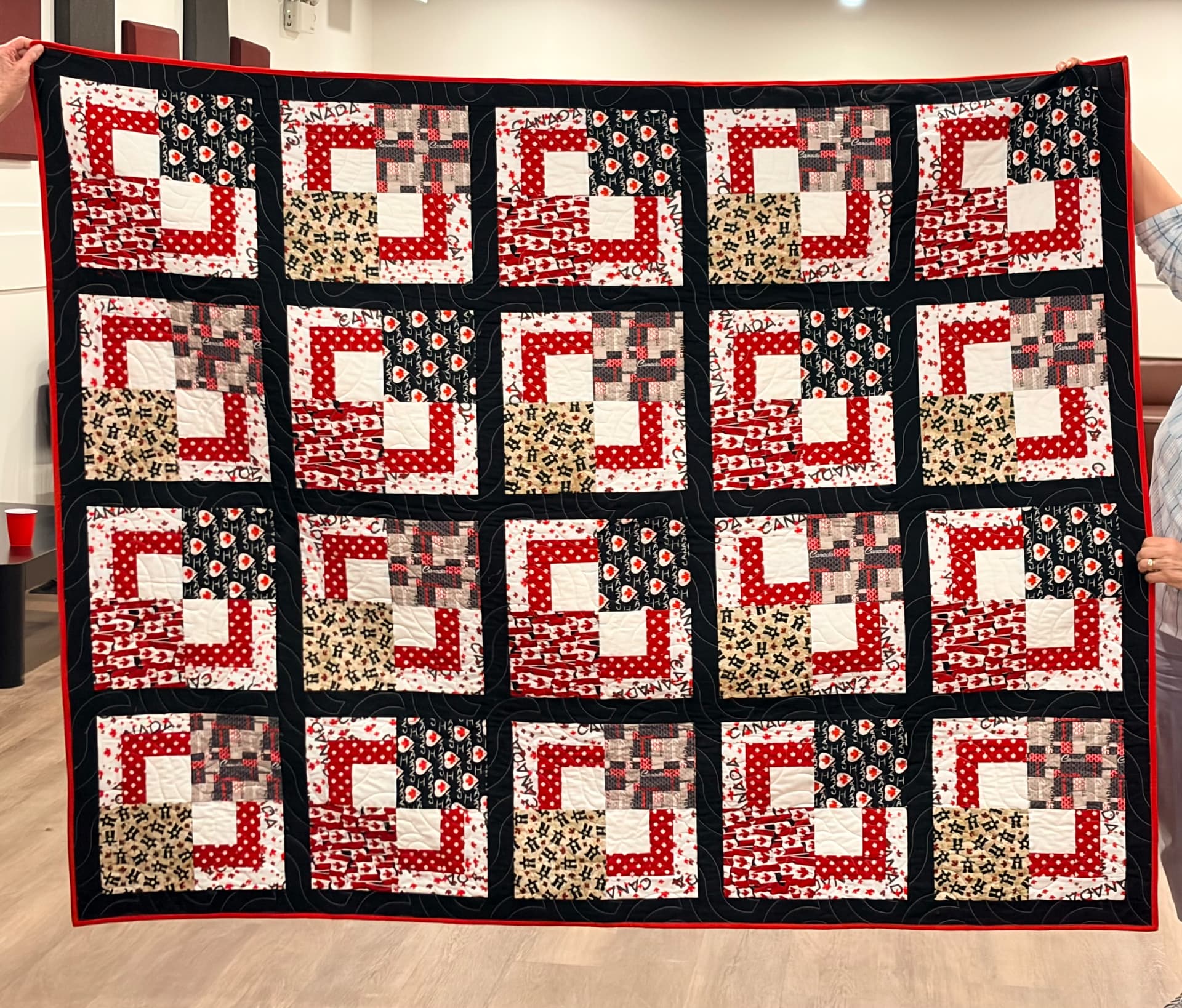 Red, white, and black Canada log cabin quilt