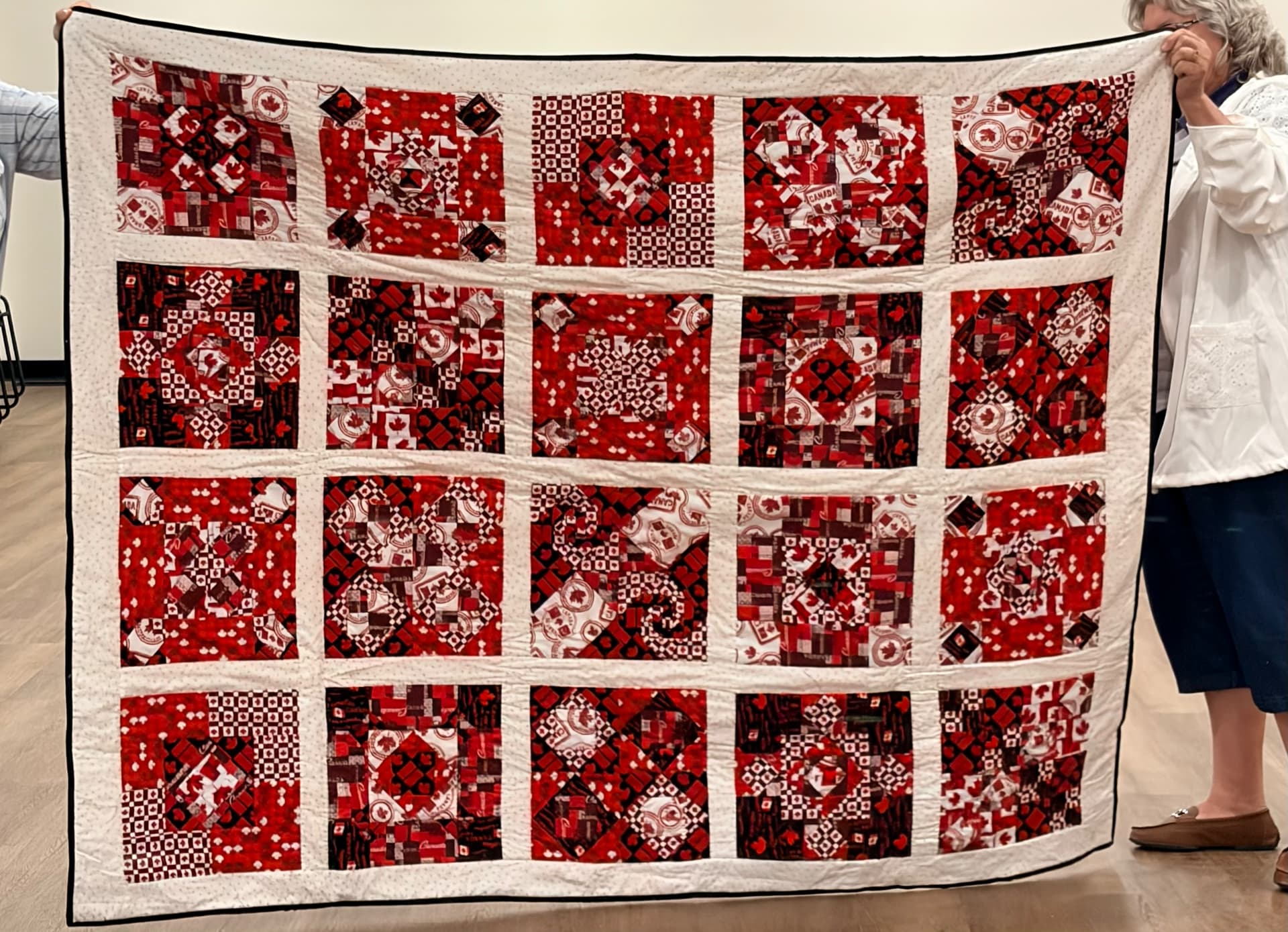 Red and white Canadiana sampler quilt with cream sashing