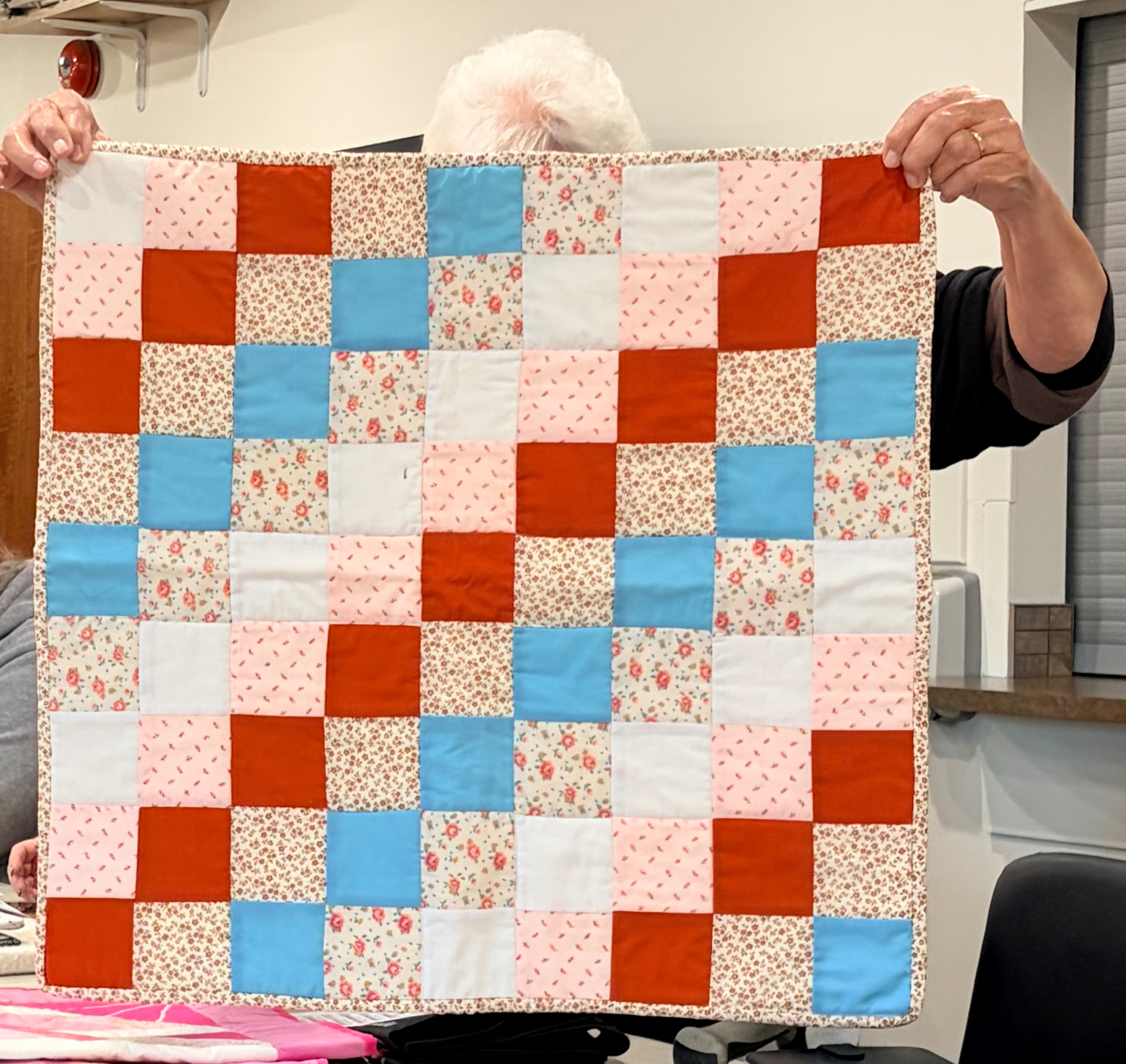 Nine-patch quilt in rust, robin's-egg blue, and pink florals