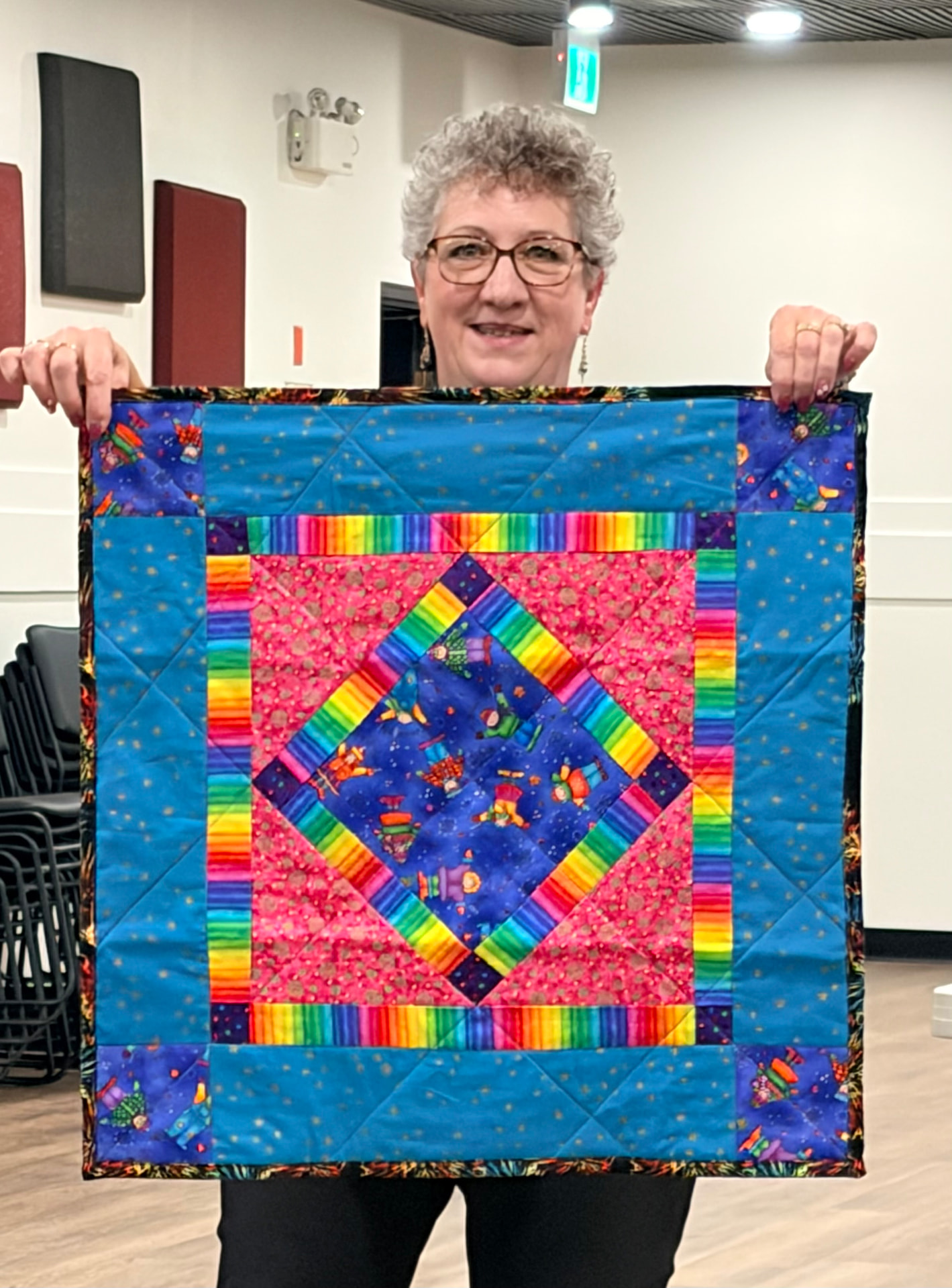 Teal, pink, and rainbow diamond quilt with layered diamond frames