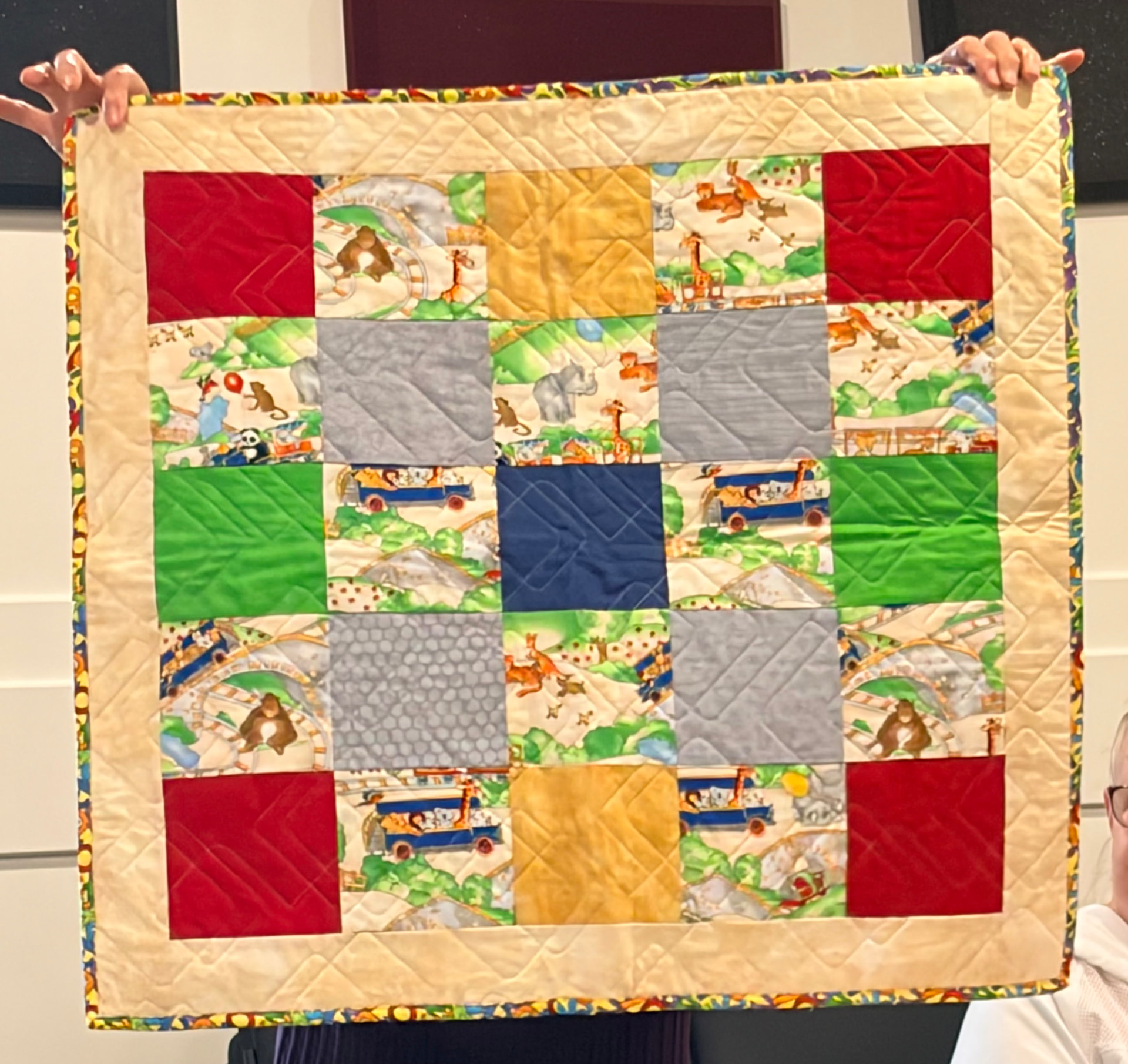 Zoo animals panel quilt framed by striped sashing