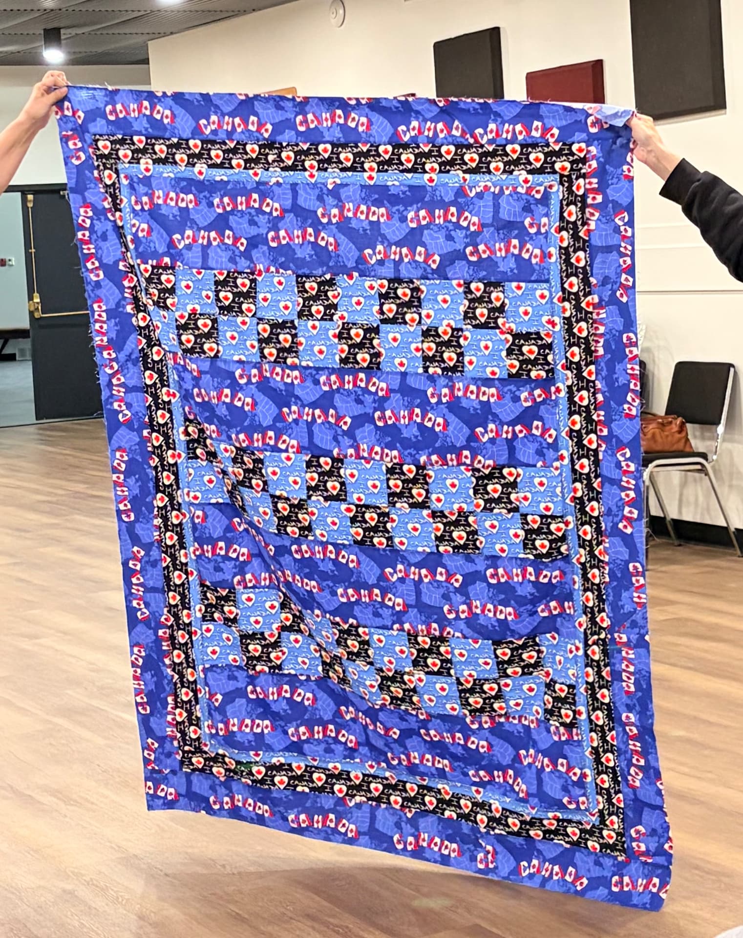 Blue Canada-print quilt with checkerboard centre blocks