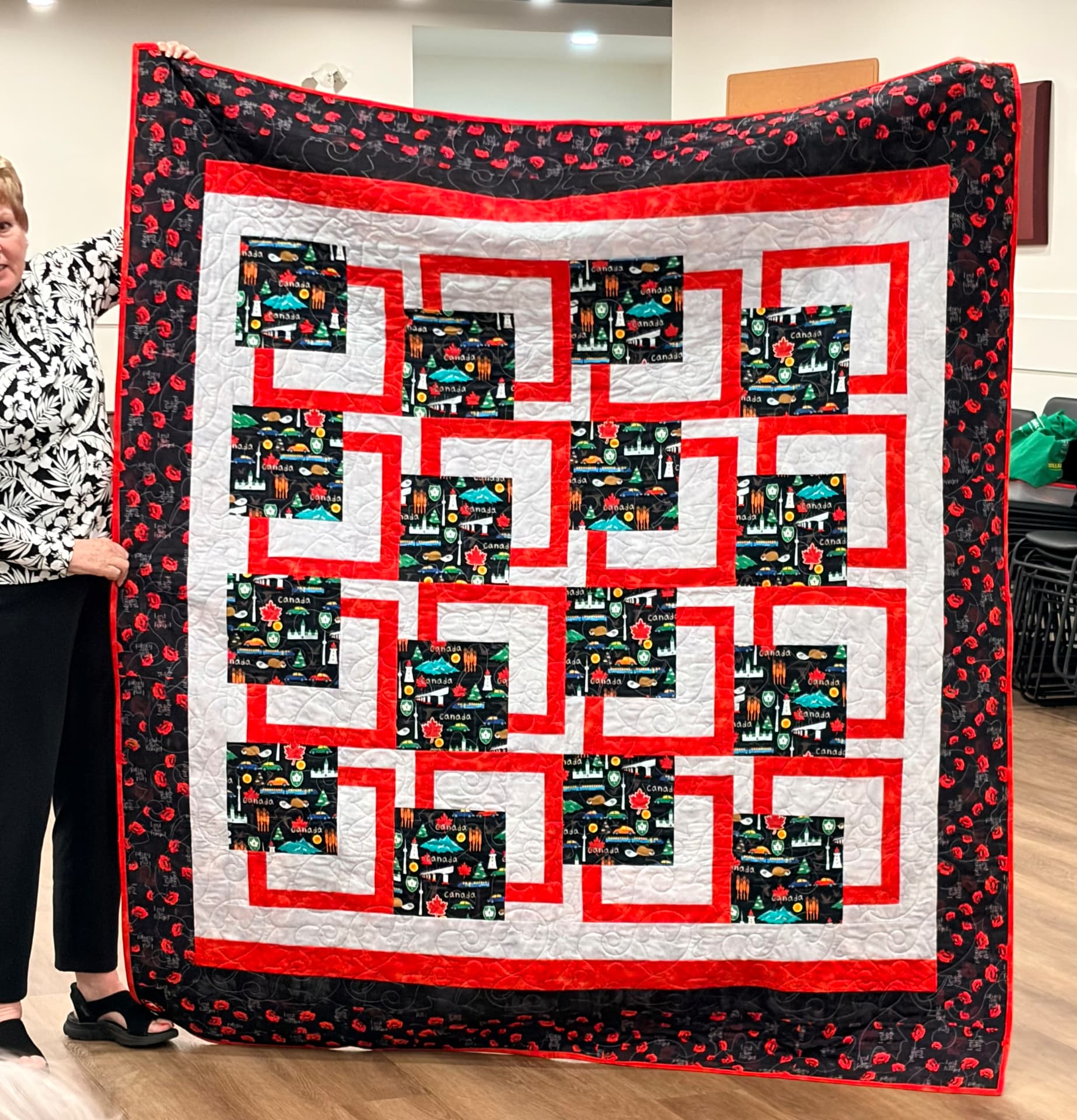 Red, white, and black Canada quilt with interlocking log cabin blocks