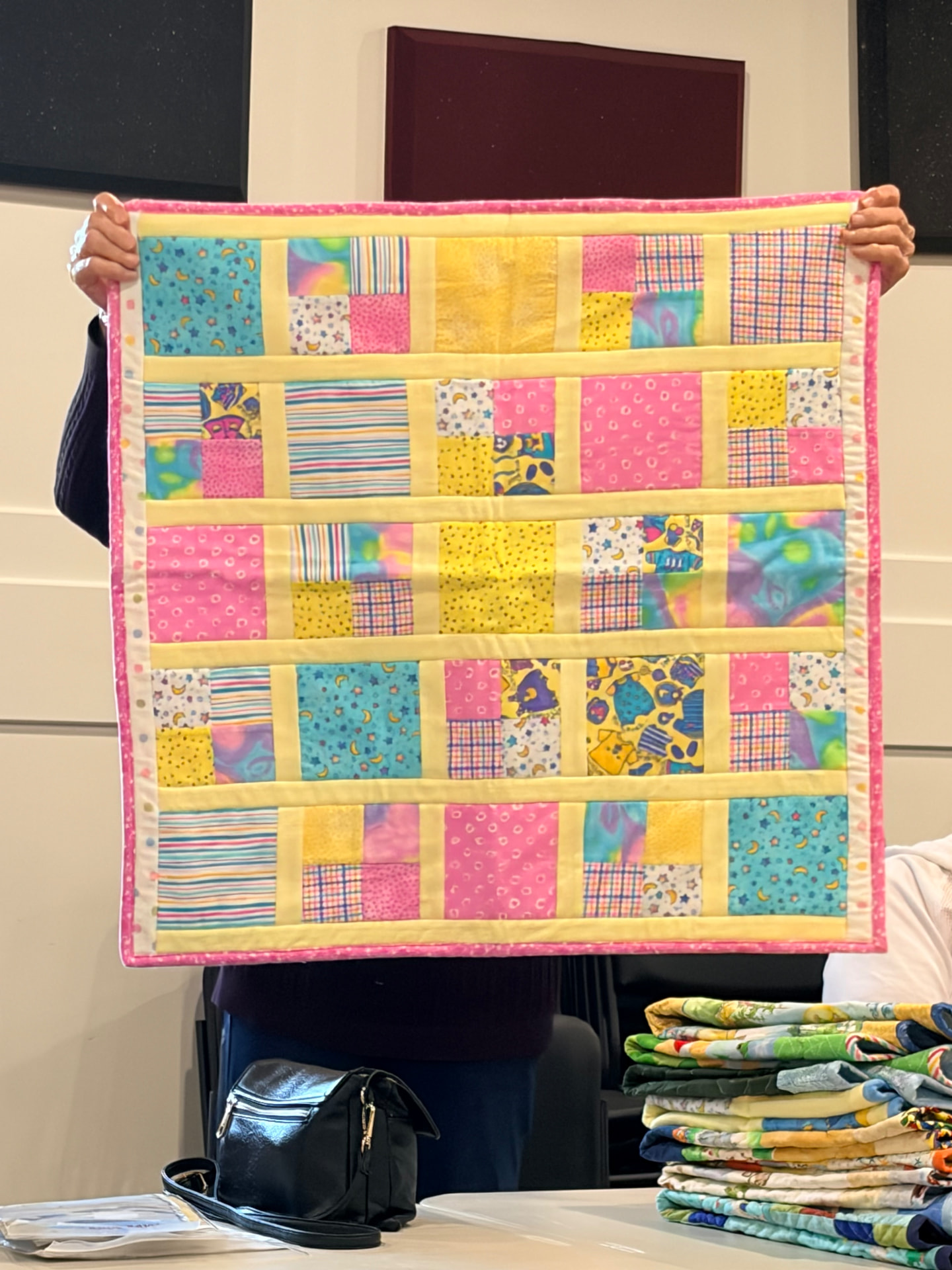 Pink and yellow checkerboard quilt with soft batik squares